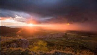 Simultaneous storm and sunset creates stunning scenery