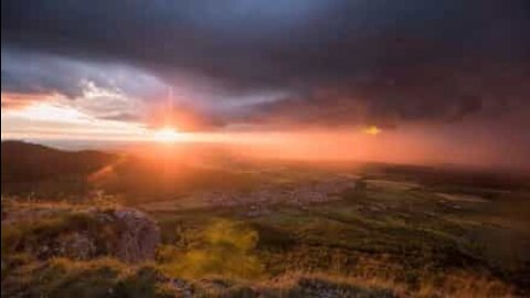 Simultaneous storm and sunset creates stunning scenery