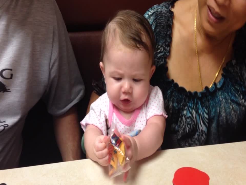 Baby has Epic Battle with Cookie Wrapper