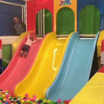 Baby Girl Slides Down Into A Ball Pool