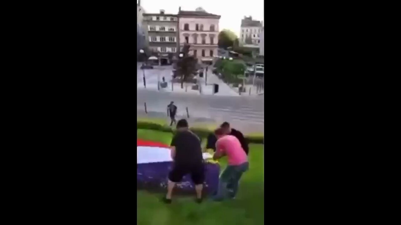 Polish activists cover flowerbed depicting Ukrainian flag with state flag on anniversary of massacre