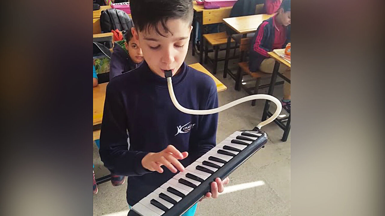 Little boy playing Melodica