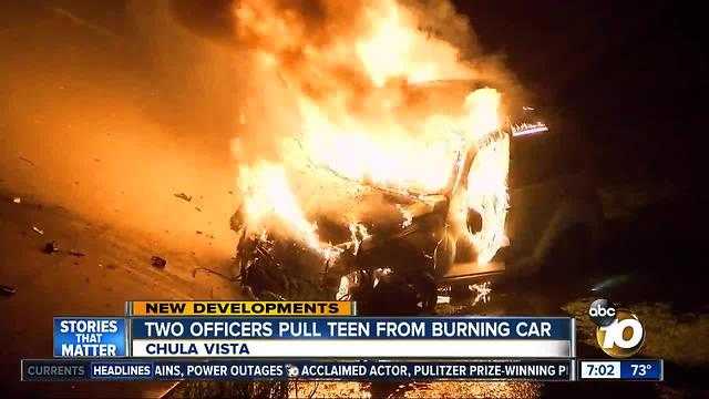 Two officers pull teen from burning car