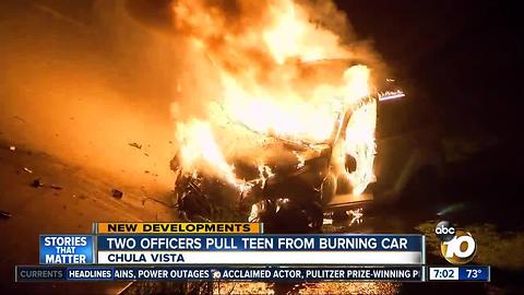 Two officers pull teen from burning car