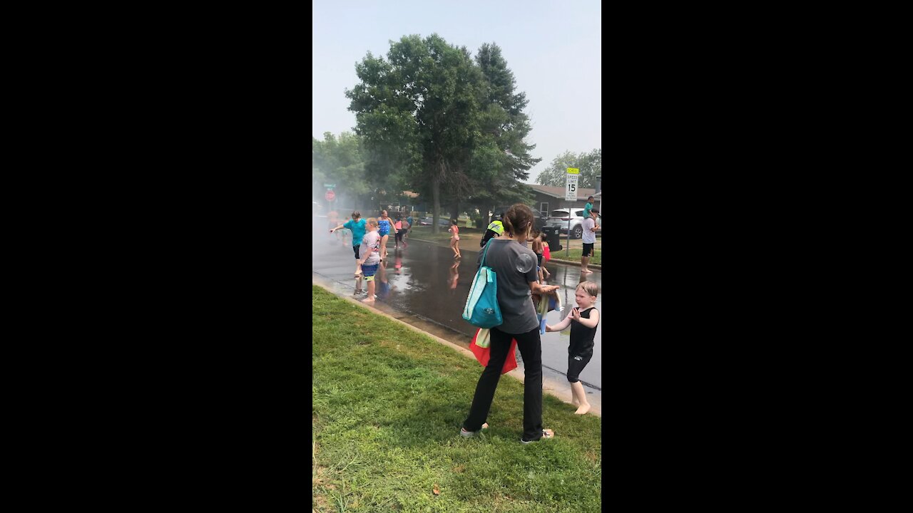 Police officer is a great sport during fire hydrant fun