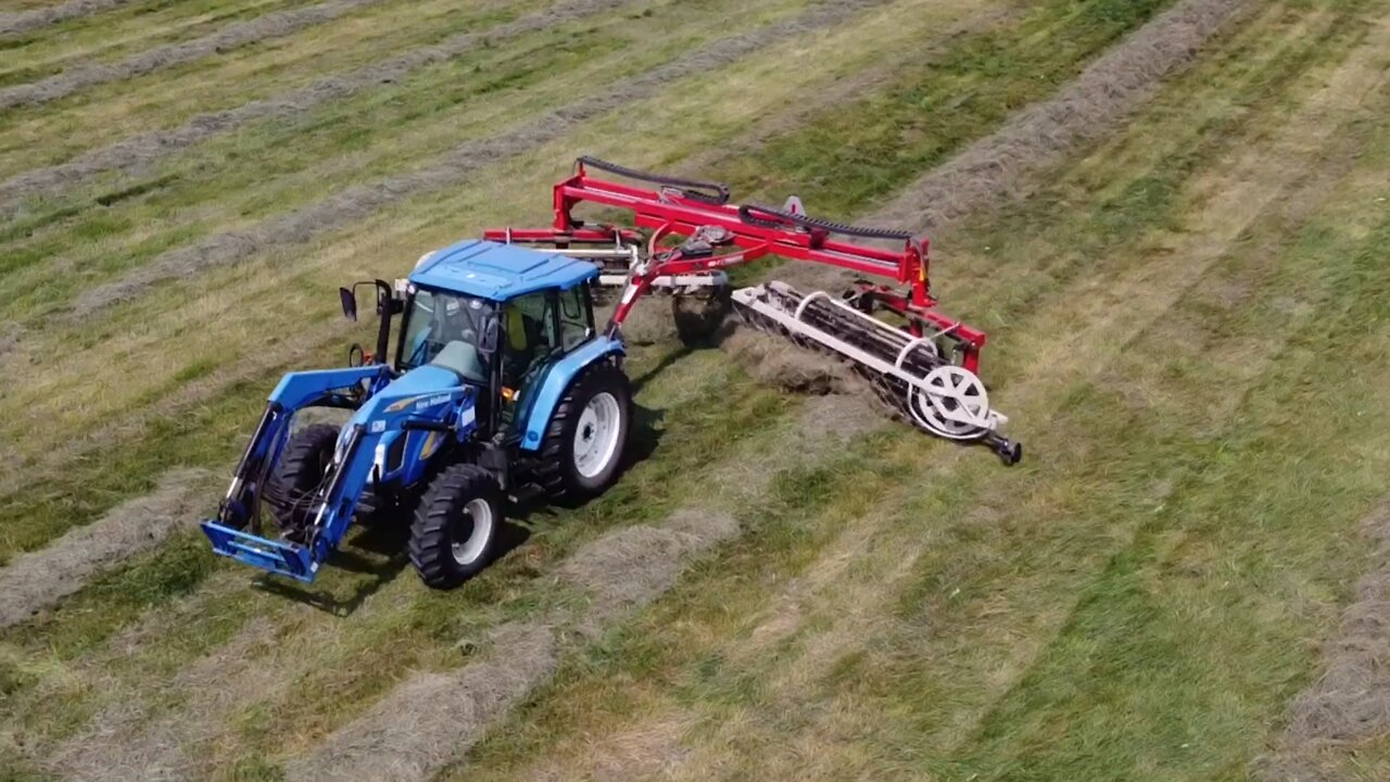 New Holland pulling a Twin Star hay rake