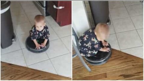 Child rides vacuum cleaner robot