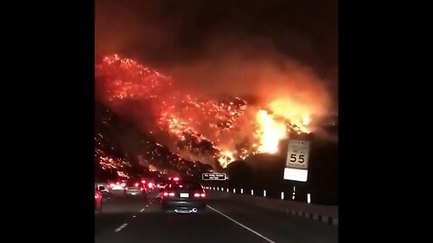 Guy drives through a wilfire