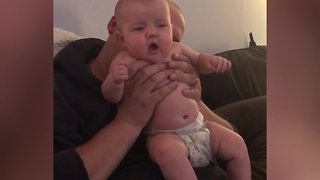 "Baby Girl Makes Surprised Face When Dad Blows Raspberries on Her Back"