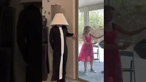 Man dressed as a lamp scares his friend