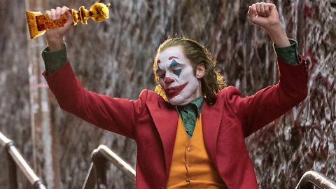 Joker Laughs Hysterically At Capitalism