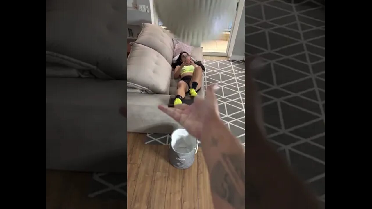 Cute model doing football tricks (from the couch)