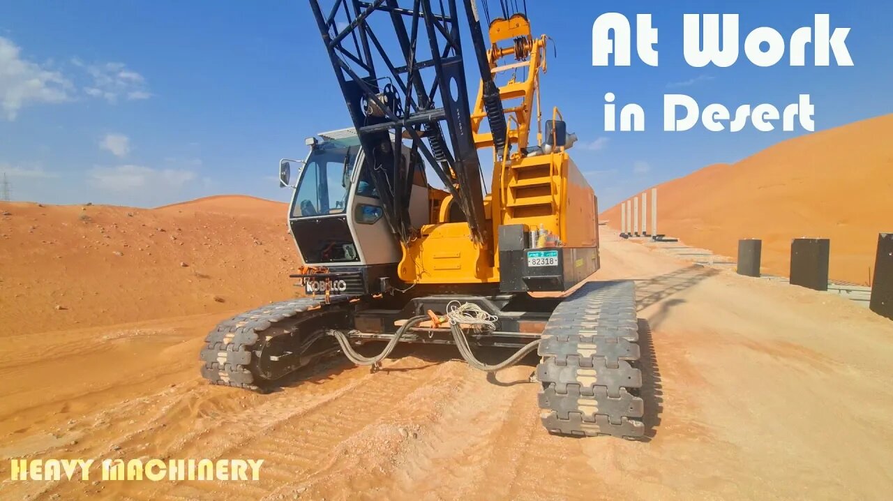 Heavy crane installing wall in desert