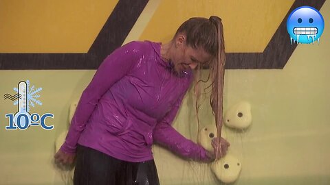 Big Brother show (US S22E17). Cold water challenge. Woman is shivering cold ice streams of water.