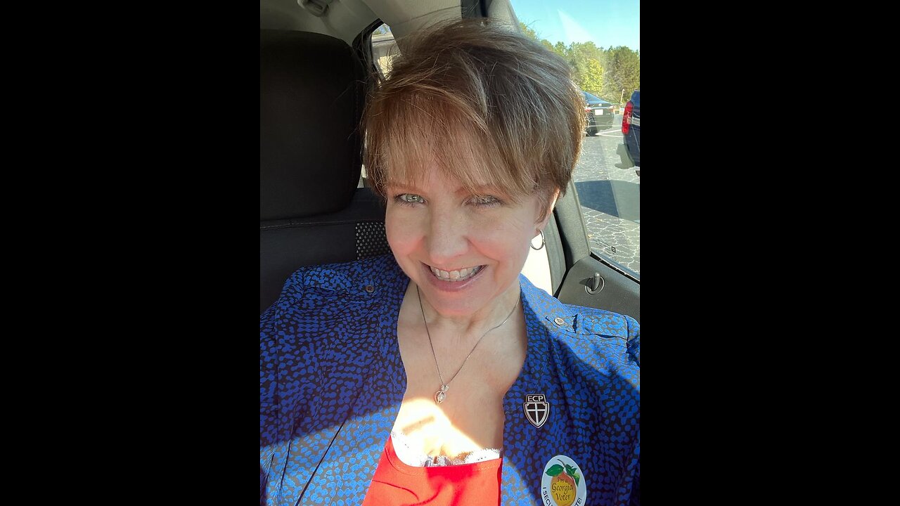 Midterms: American lady votes. Wearing the ECP badge.