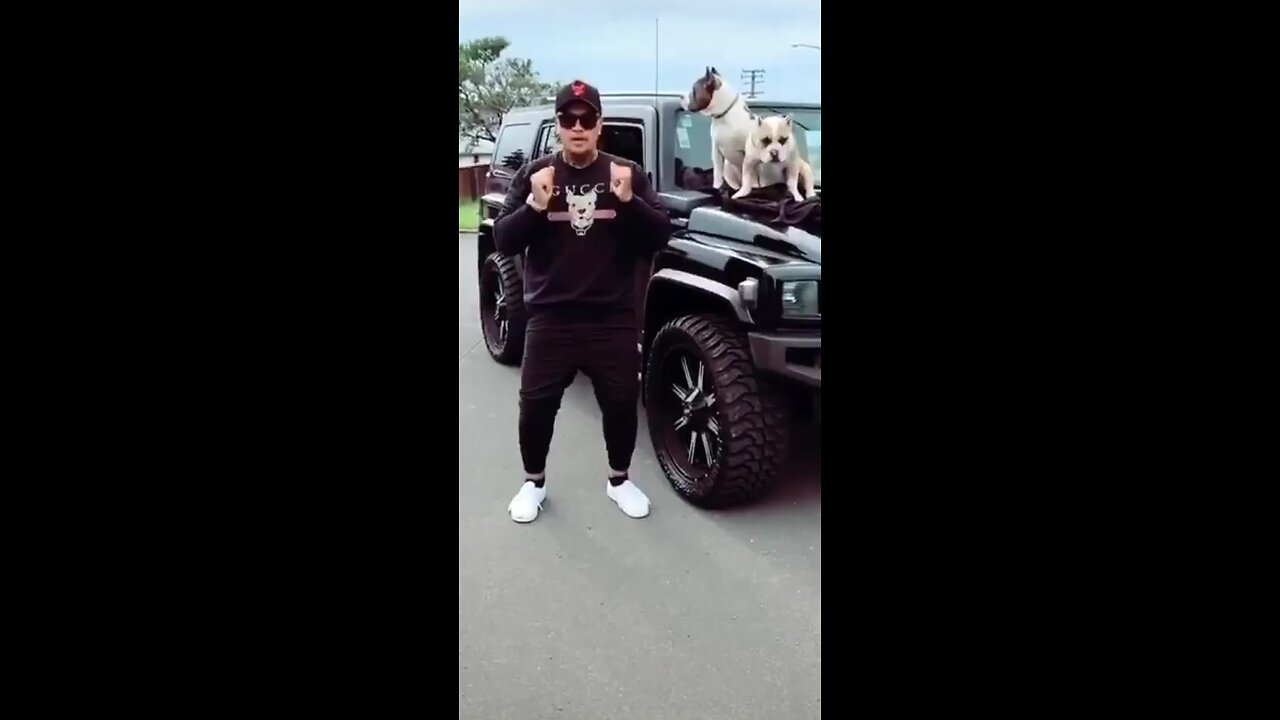 Man shows off his dance with his dog and hummer/26 rims