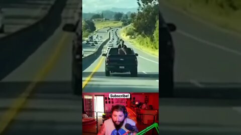 Woman climbs onto truck on highway
