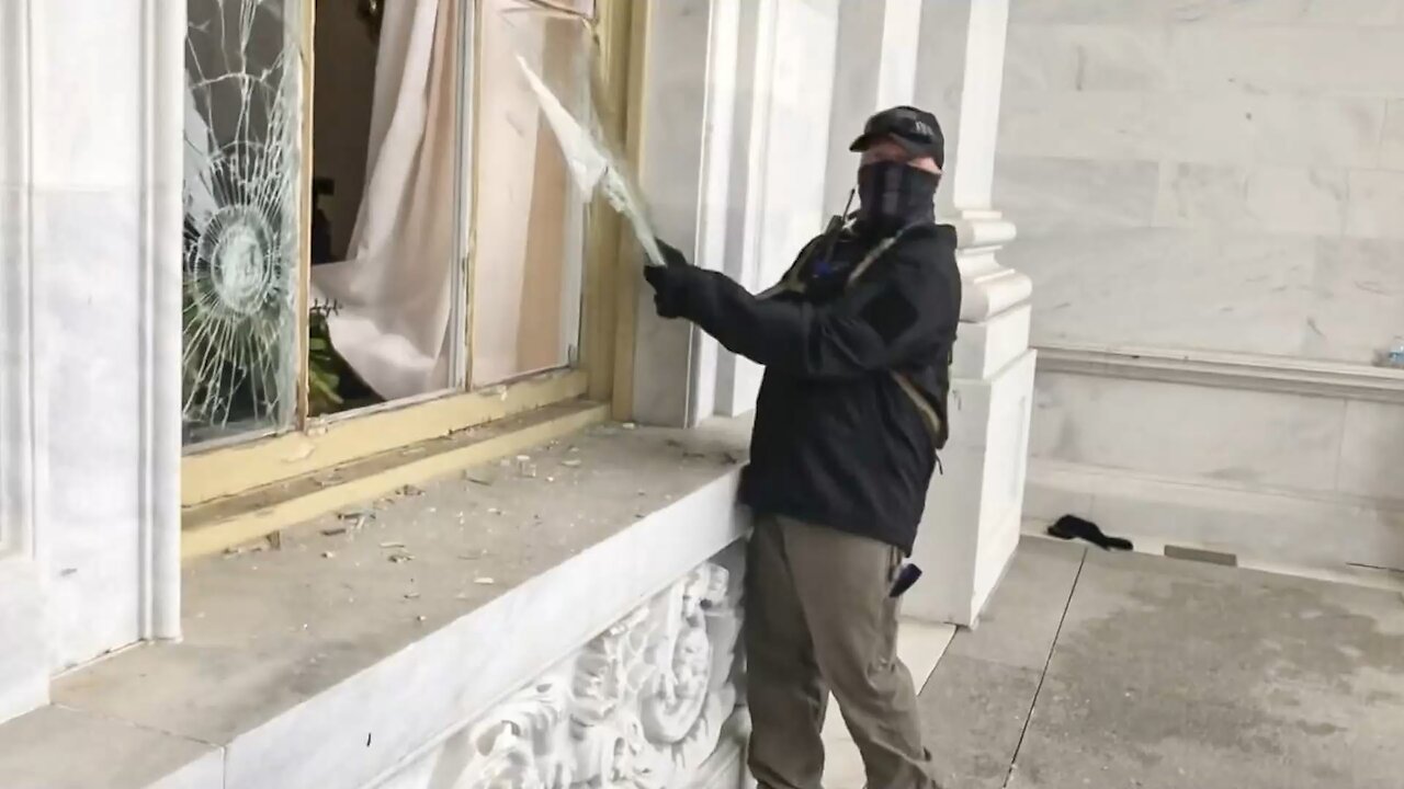 January 6th masked man with earpiece destroys a window and blames it on another man at the Capitol