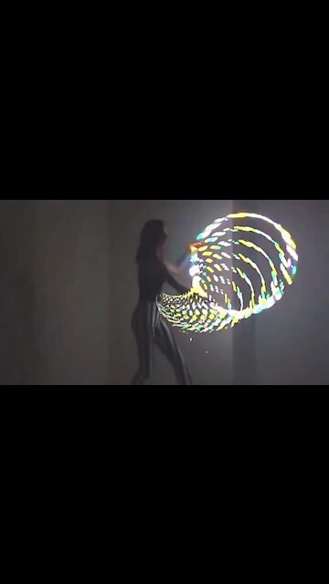 Talented girl performs incredible tricks with LED hula hoop