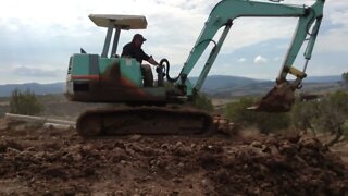 Yanmar Excavator Working On The Dam