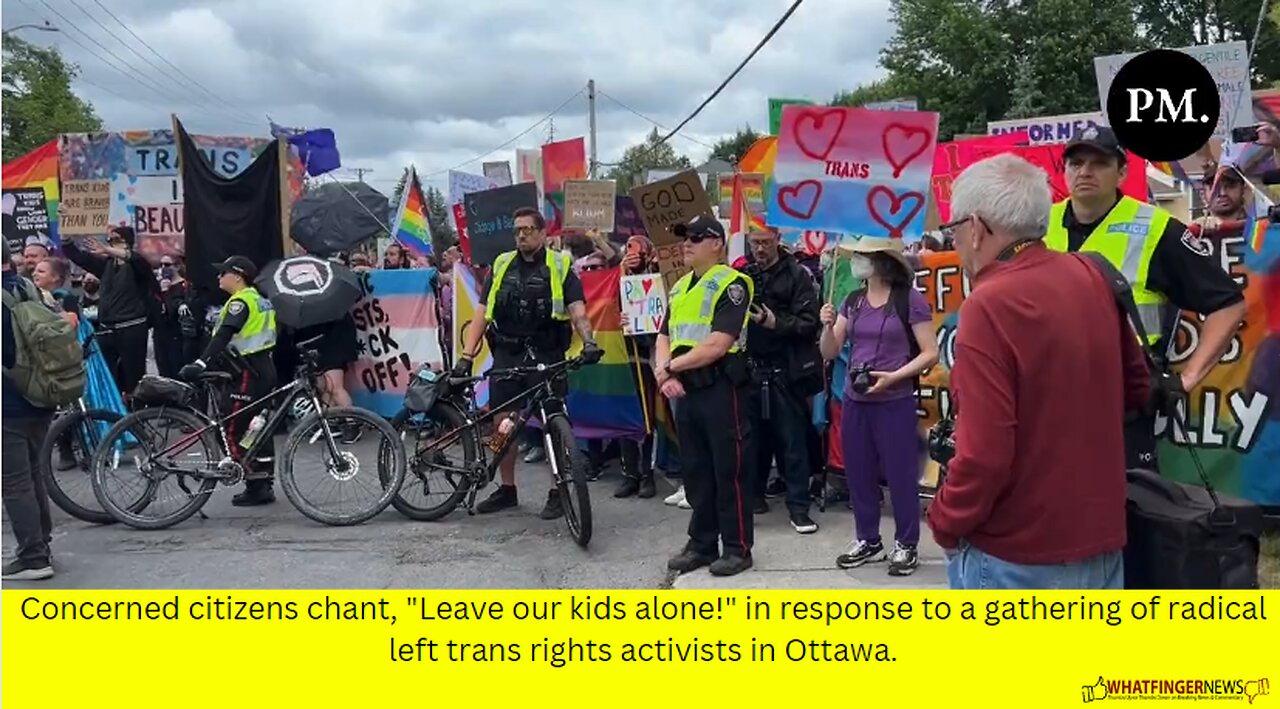 Concerned citizens chant, "Leave our kids alone!" in response to a gathering of radical