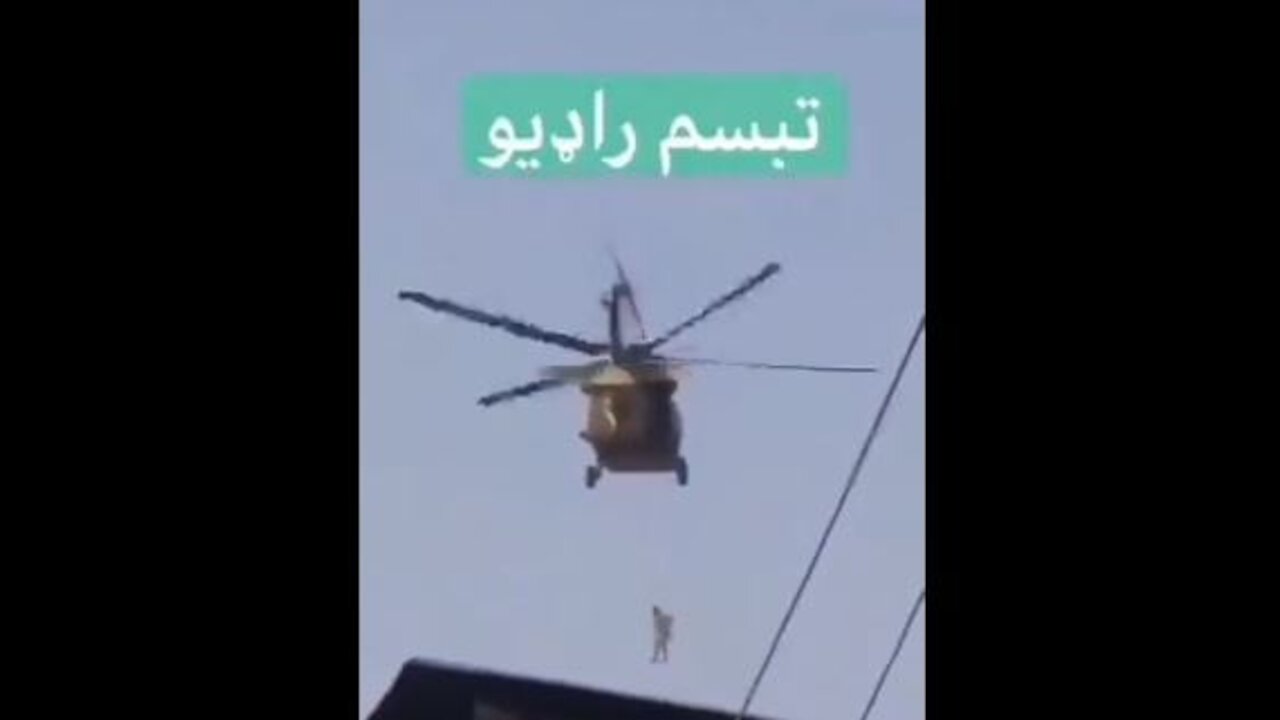 8-31-21Taliban Flies Black Hawk Helicopter Over Kandahar With Man Hanging