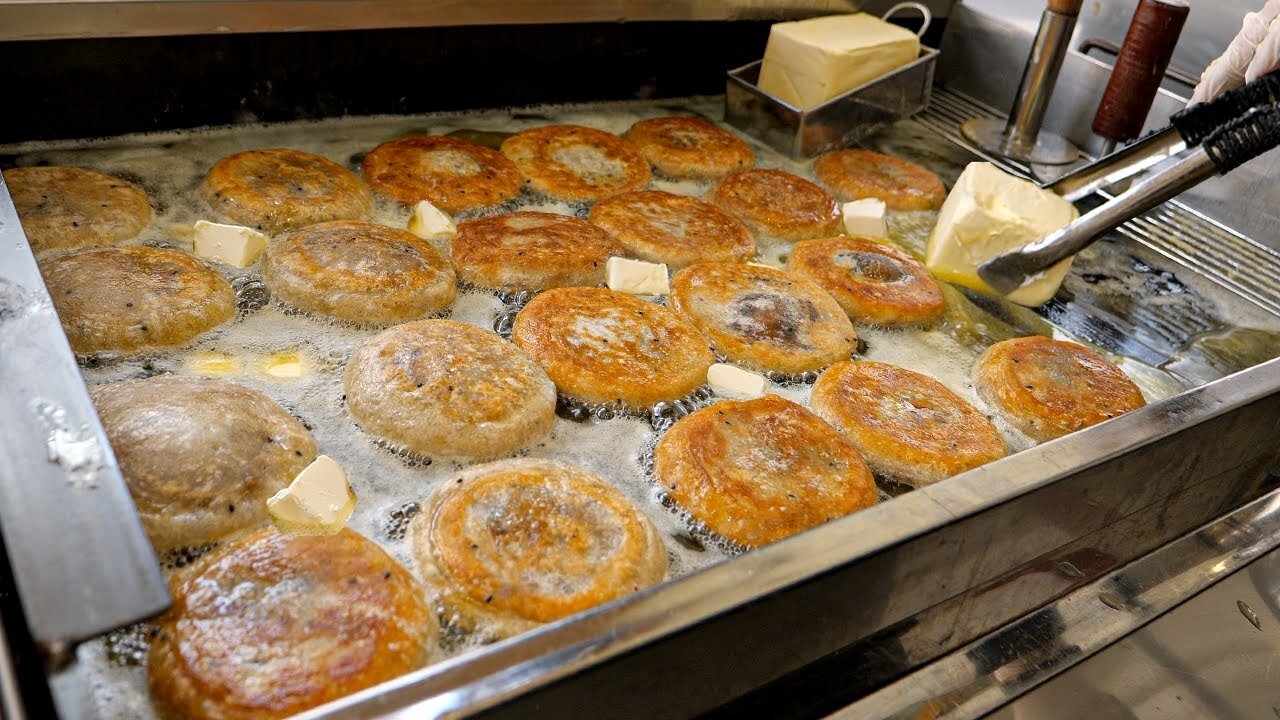 Korean-style sweet pancake, Hotteok, fried in butter - Korean street food