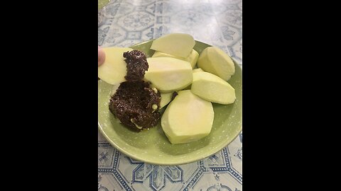 Eating green mango with shrimp paste