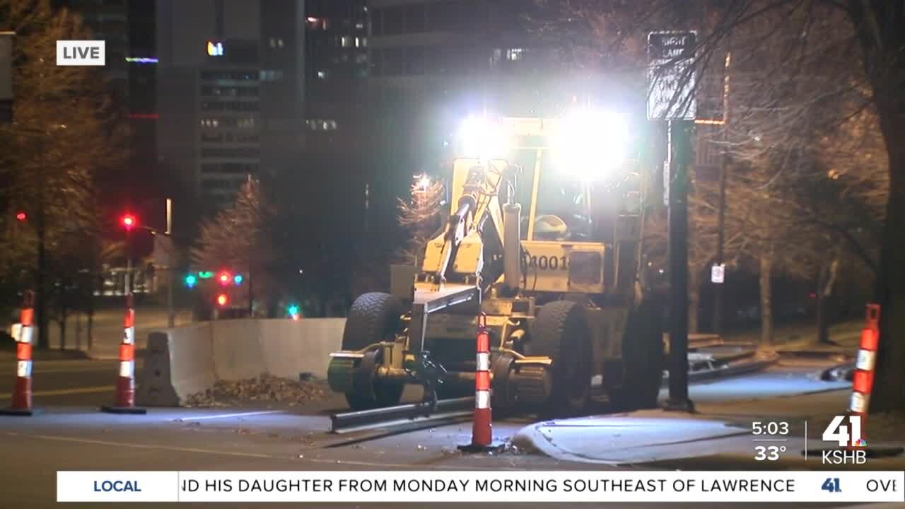 Streetcar construction crews move rail into position