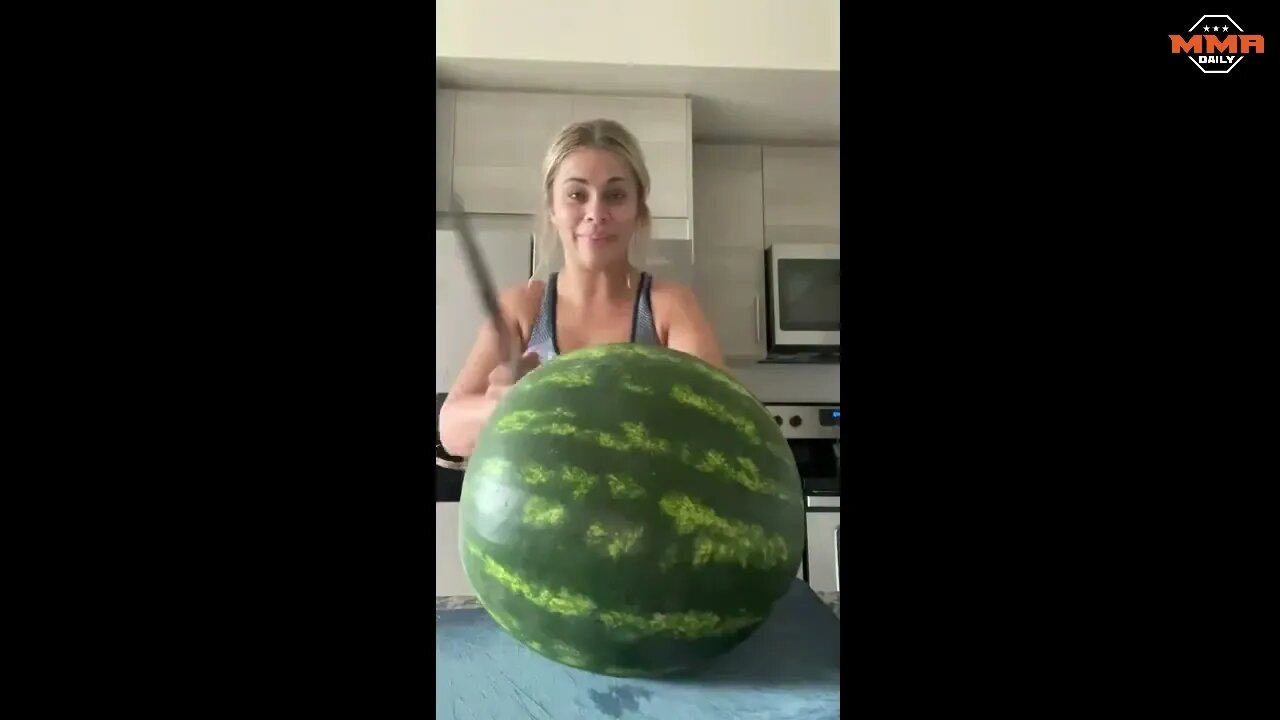 Paige VanZant trying to chop a watermelon with one strike