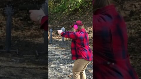 Flannel Woman Shooting Pistols