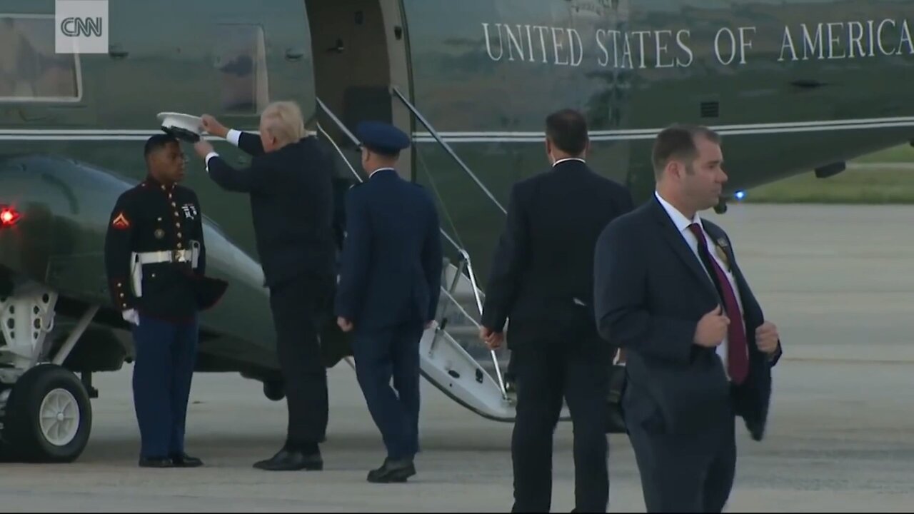 Trump stops to pick up Marine's hat