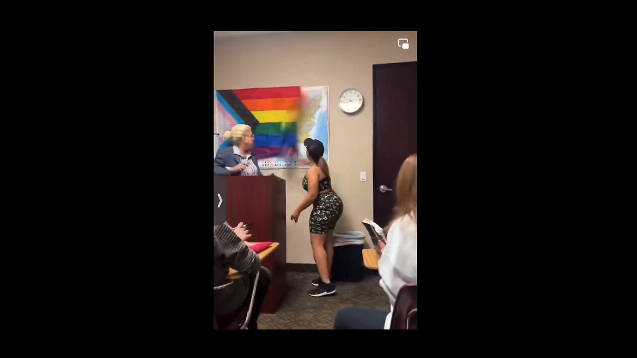 Pride flag hung in front of the US flag.