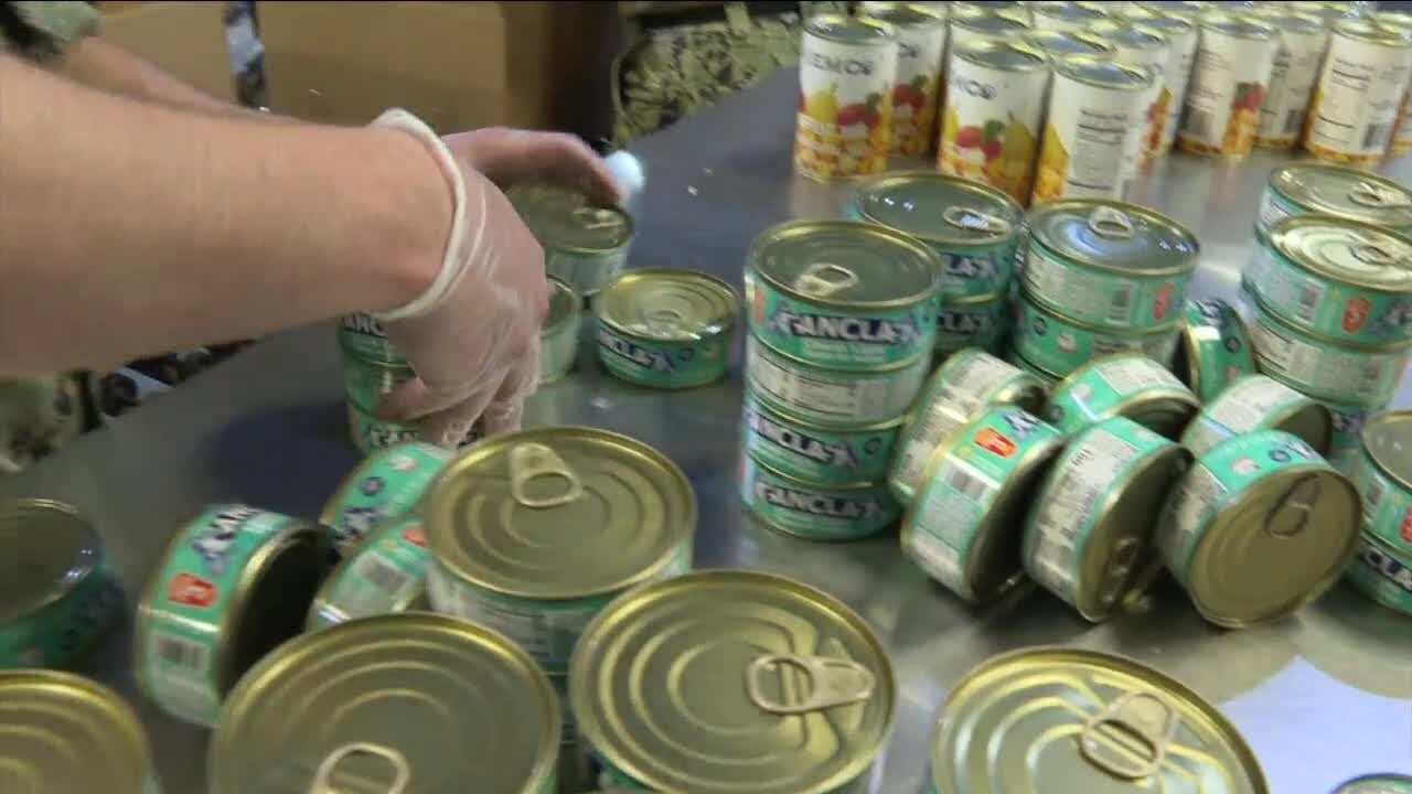 Sailors from around the country help pack food at Feeding Tampa Bay