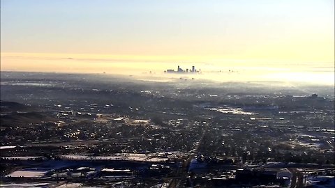 Low clouds clearing at sunrise in Denver