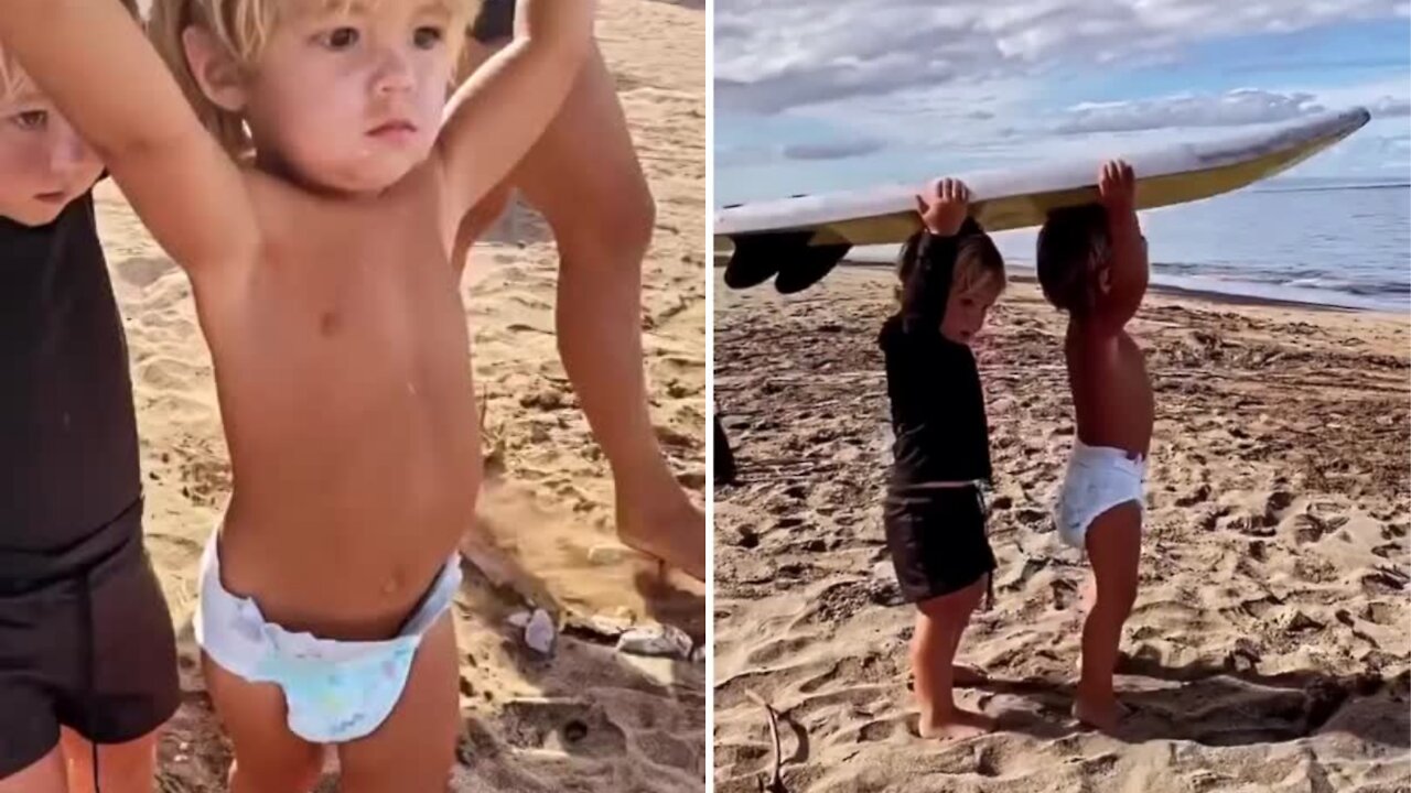 Two kids going for surfing taking surfboard over their head