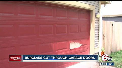 Downtown burglars cutting through garage door