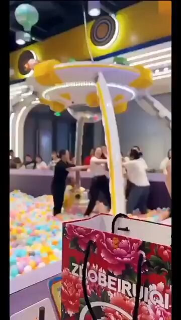 Women fighting in a ball pit