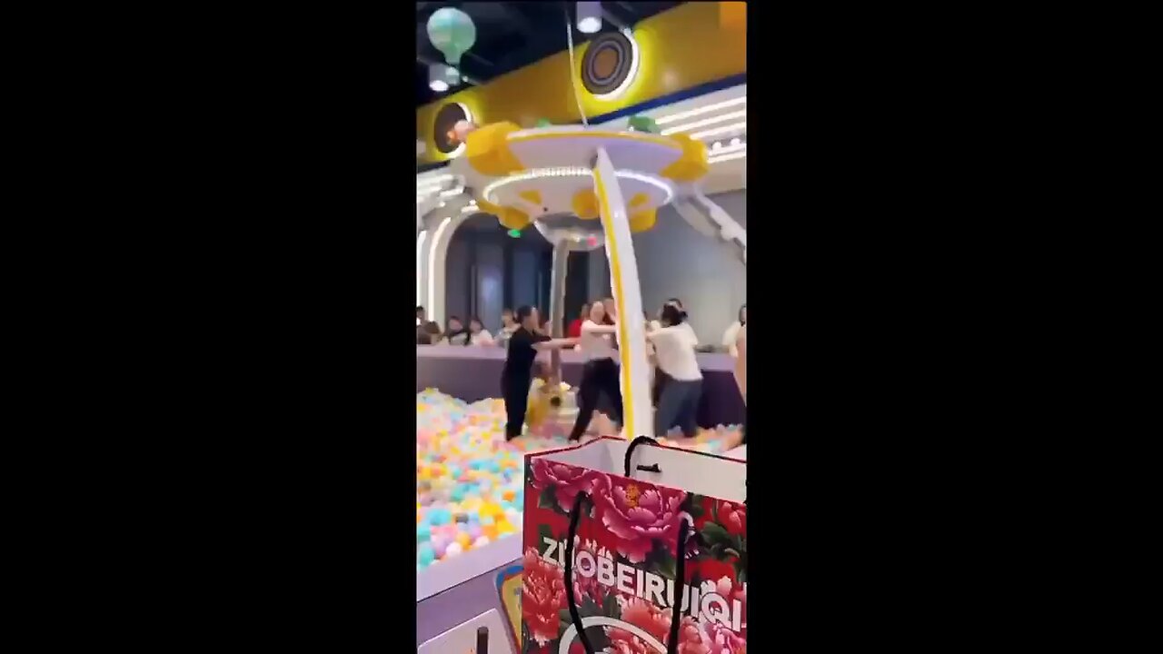 Women fighting in a ball pit