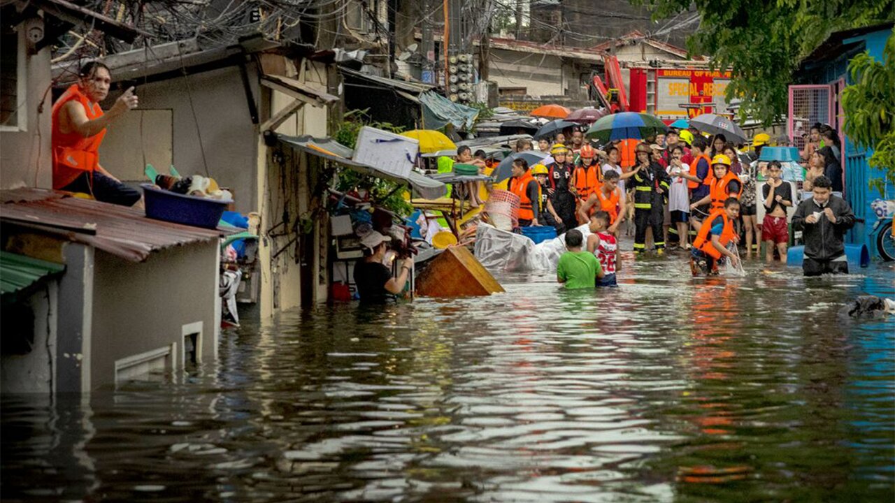 Storm-triggered floods in Philippines spark frantic calls to rescue trapped people, some on roofs