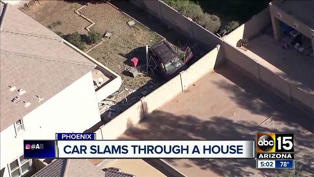 Car slams through Phoenix home