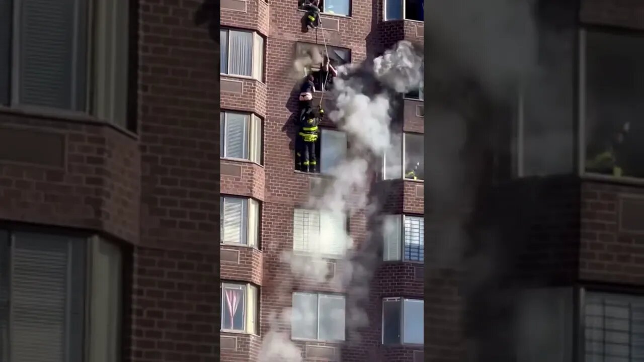 FDNY save a women hanging outside a window during a fire😳#crazyvideo #shorts #fire #fdny #newyork