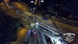 Metropolitan erecting bridge steel at night.