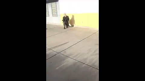 Teacher kneeling for the flag