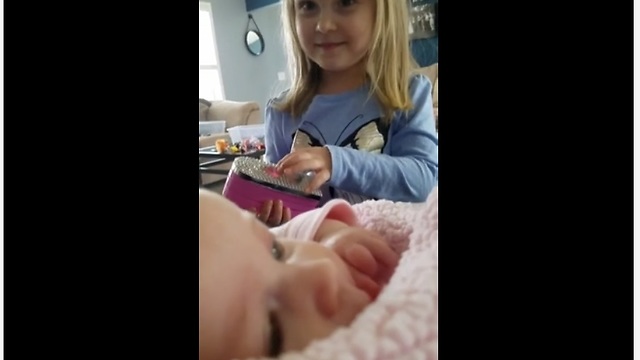 Toddler preciously makes her baby sister laugh