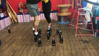 Circus artists walk on glass bottles