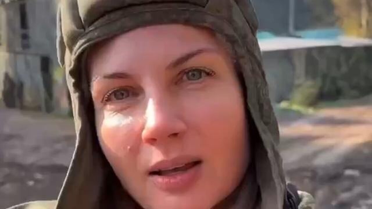 Russian soldier says they will take Kiev, and then Berlin. Behind her is the USSR flag