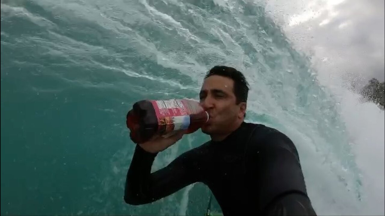 Surfer takes on viral trend and drinks cranberry juice on the waves