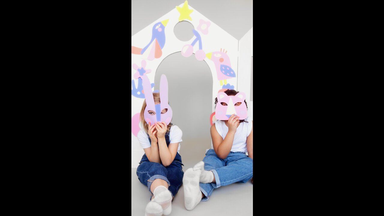 Kids playing with decorated paper house