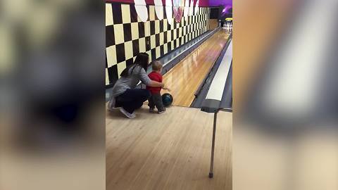 A Tot Boy Runs Down On A Bowling Lane